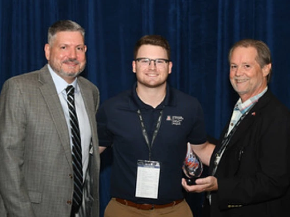 Eric DeCoster receiving award