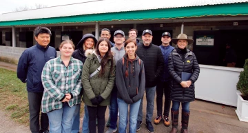 RTIP students and Gayle Van Leer in front of barn