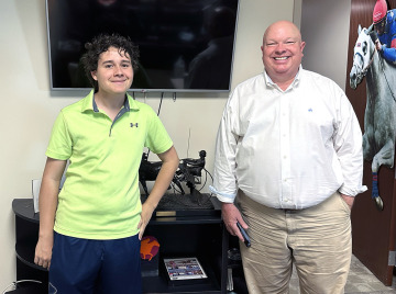 Nathan Klein and Mike Tanner standing in front of a TV at the RTIP offices